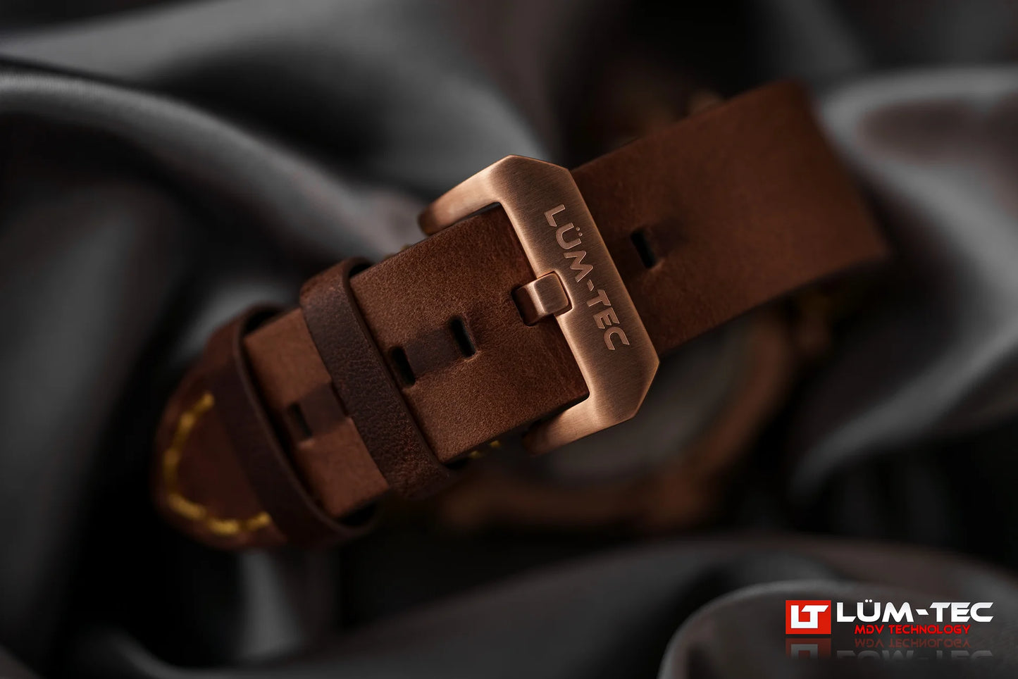Close-up of Lum-Tec M94 Bronze GMT bronze buckle and leather strap