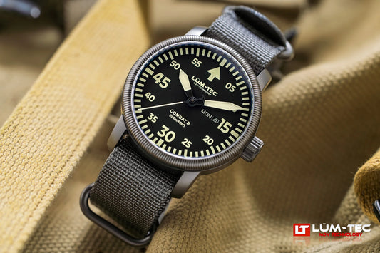 Lum-Tec Combat B68 Day-Date front view showing luminous day and date windows with gray NATO strap