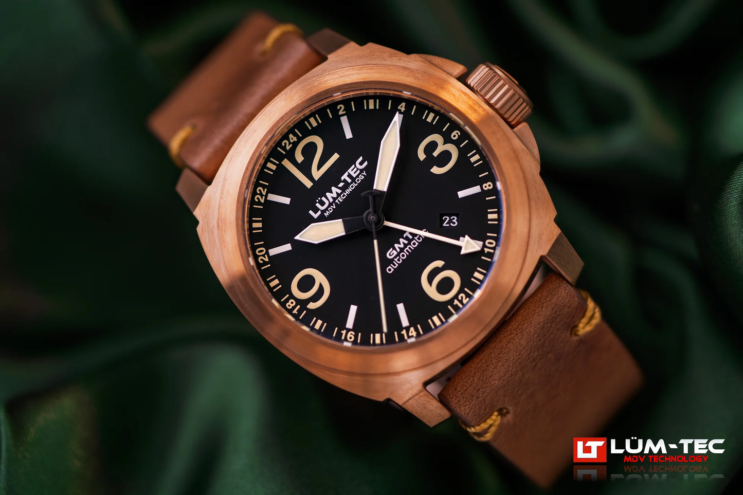 Close-up of Lum-Tec M94D Bronze GMT Date showing brushed bronze case, black dial, and date window
