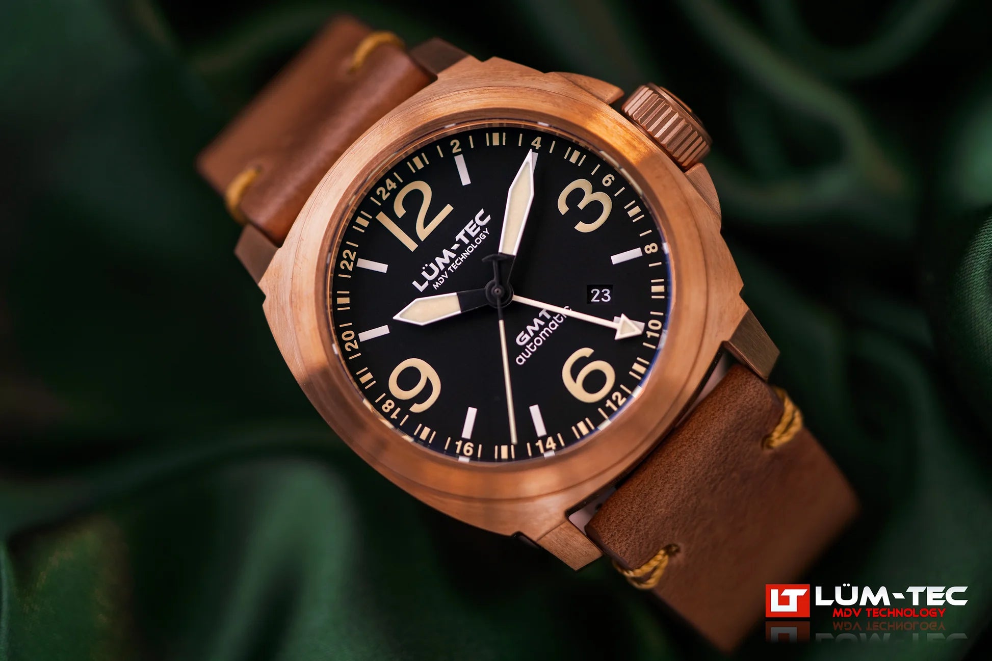 Close-up of Lum-Tec M94D Bronze GMT Date showing brushed bronze case, black dial, and date window