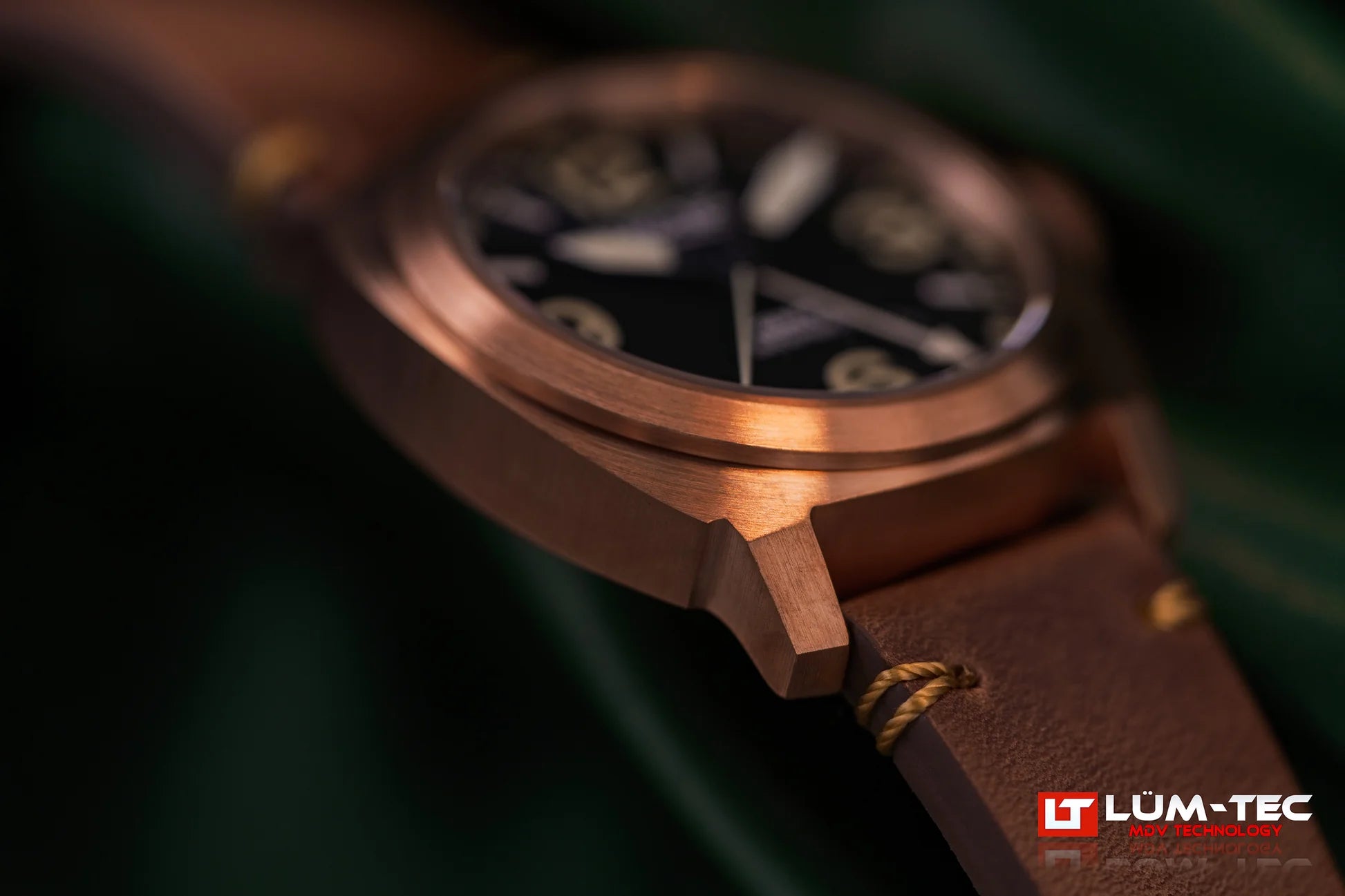 Macro shot of Lum-Tec M94D Bronze showing brushed bronze case, crown, and leather strap